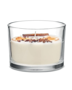 Candela profumata in vetro con fiori e frutti secchi